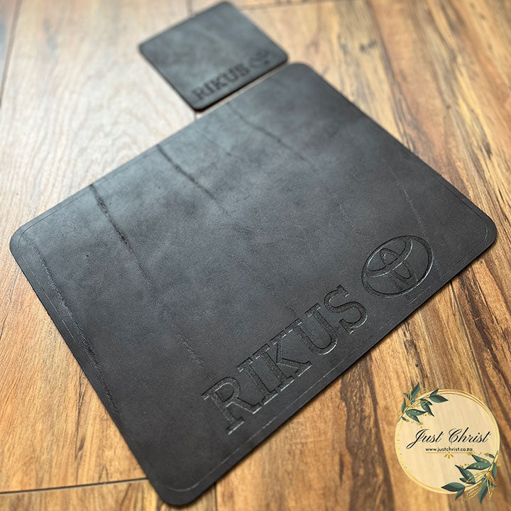 A standard mousepad and matching coaster set is placed on wood laminated flooring. The colour of the leather is dark brown. 